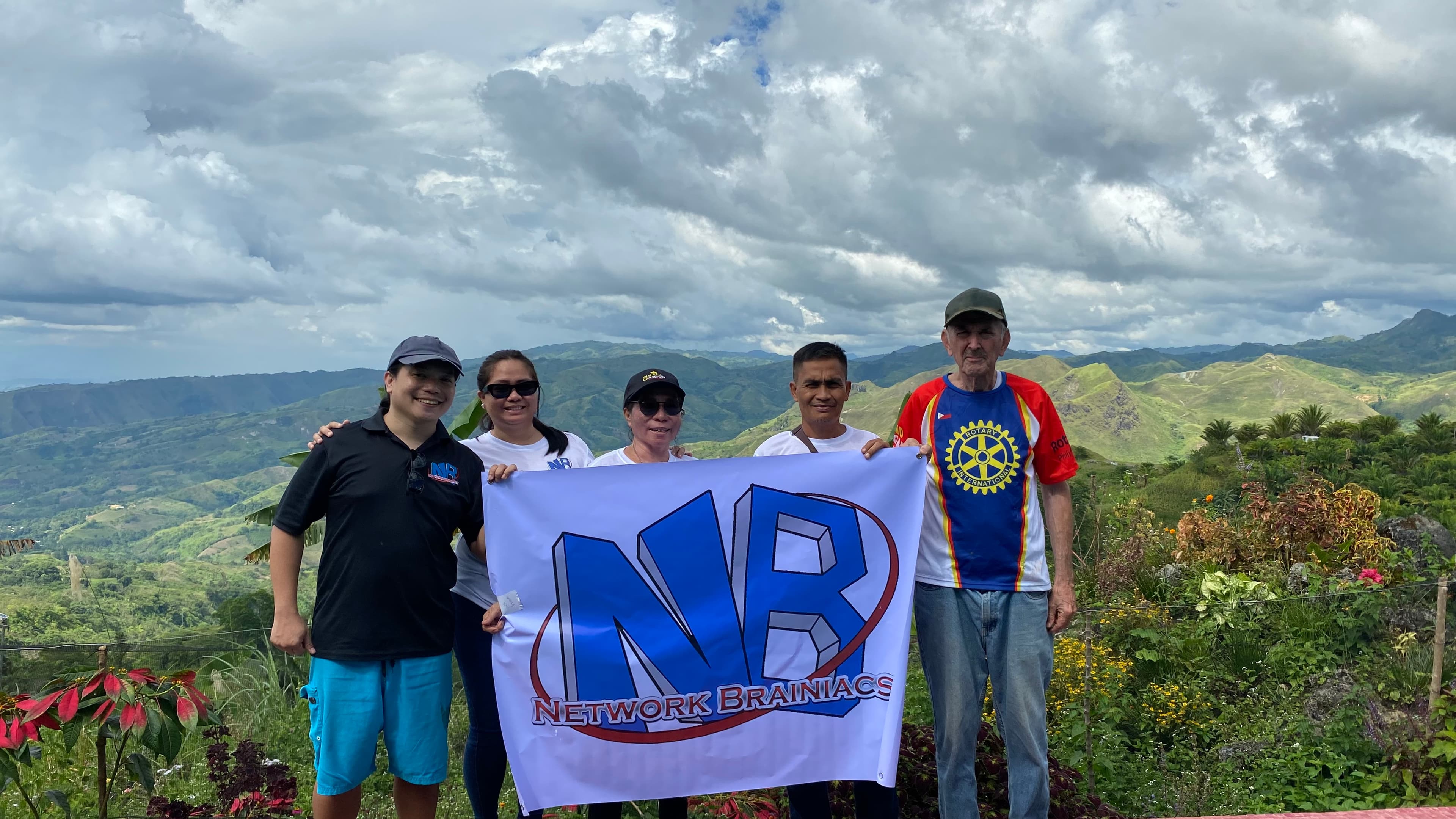 Network Brainiacs team with the Rotary Club of East Davao against the Philippine mountains